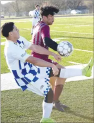  ?? Westside Eagle Observer/MIKE ECKELS ?? Andres Revolorio (left) goes into an overhead kick in an attempt to keep the ball away from a Wolves player during the March 17 Lincoln-Decatur soccer match at Wolves Stadium in Lincoln. The Bulldogs took the match, 1-0, over the Wolves.