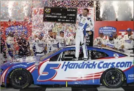  ?? CHRIS GRAYTHEN — GETTY IMAGES ?? Driver Kyle Larson celebrates with the $1million check in victory lane after winning the NASCAR Cup Series All-Star Race at North Wilkesboro Speedway on Sunday.