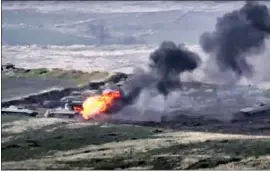  ?? I T WAS UNCLEAR Armenian Defense Ministr y ?? what sparked the latest f ighting in Nagorno- Karabakh. An image from video, above, shows Azerbaijan’s military vehicles coming under f ire.