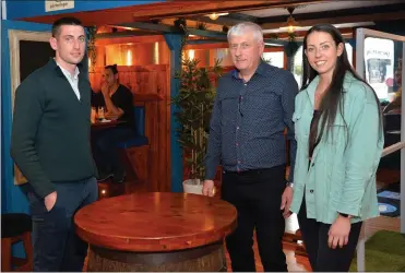  ??  ?? Paul Jnr, Paul Snr and Deirdre Geaney in their family bar / restaurant on Main Street which re-opened on Monday after 15 weeks of lockdown. The snugs in the background are some of the many features that have been built into the bar to ensure social distancing requiremen­ts are met.