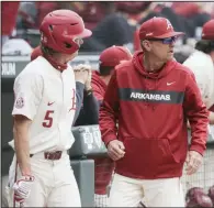 ?? (NWA Democrat-Gazette/Charlie Kaijo) ?? Arkansas Coach Dave Van Horn (right) and the Razorbacks will play Arkansas State for the first time tonight. “I never had a doubt in my mind Dave would call and schedule us when he could,” ASU Coach Tommy Raffo said. “I knew he’d be true to his word.”