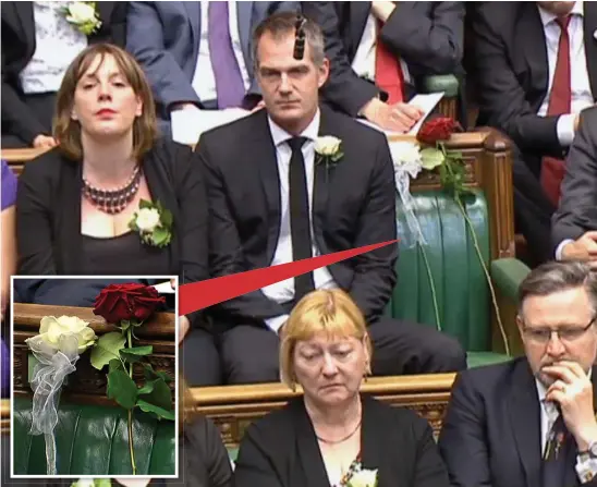  ??  ?? Poignant: Two roses – red for Labour, white for Yorkshire – are placed in the spot where Jo Cox would have sat as Commons colleagues listen