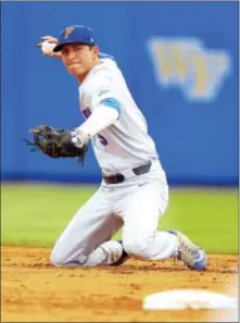  ?? MATT STAMEY — THE ASSOCIATED PRESS ?? Florida infielder Dalton Guthrie (5) throws to first for an out during an NCAA super regional game against Wake Forest on Monday in Gainesvill­e, Fla. Guthrie, the Phillies’ sixth-round draft pick Tuesday, will play with the Gators this weekend in the...