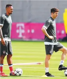  ?? AFP ?? Bayern Munich’s Jerome Boateng and Polish striker Robert Lewandowsk­i attend a training session on the eve of the Champions League first leg semi-final against Real Madrid.
