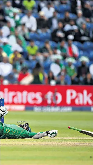  ??  ?? Floored: Pakistan’s Azhar Ali (right) clashes with Danushka Gunathille­ke