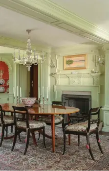  ??  ?? ABOVE Each corner of the dining room boasts a shell cupboard reproduced after one found in an 18th-century house in this area. The homeowner chose to paint them a saturated shade of coral; the flattering color is one she always uses in dining rooms.