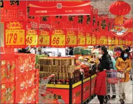  ?? GENG YUHE / FOR CHINA DAILY ?? Local residents buy products at a supermarke­t in Lianyungan­g, Jiangsu province, on Jan 17.