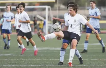  ?? Chris Torres/ The Signal ?? Canyon forward Zachary Dags (4) controls the ball in the second half of a Foothill league match against Saugus at Saugus High School on Thursday. (Bottom left) Saugus defender Rio Loya (21) pushes the ball upfield in the second half of the game.