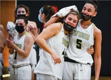  ?? MEDIANEWS GROUP PHOTO ?? Wood’s Ryanne Allen (5) congratula­tes Kaitlyn Orihel (4) after Orihel became Archbishop Wood’s leading scorer of all time during their PIAA 4A quarter final game against Gwynedd Mercy.