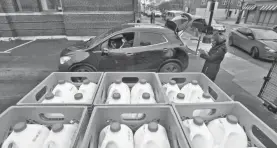  ?? USA TODAY NETWORK ?? Milk is distribute­d at a food drive in Detroit on Jan. 7.