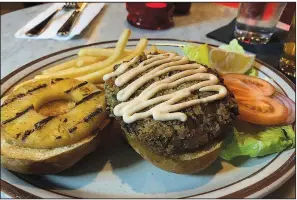  ?? Arkansas Democrat-Gazette/ERIC E. HARRISON ?? The Hawaiian Crab Cake sandwich comes with fries.