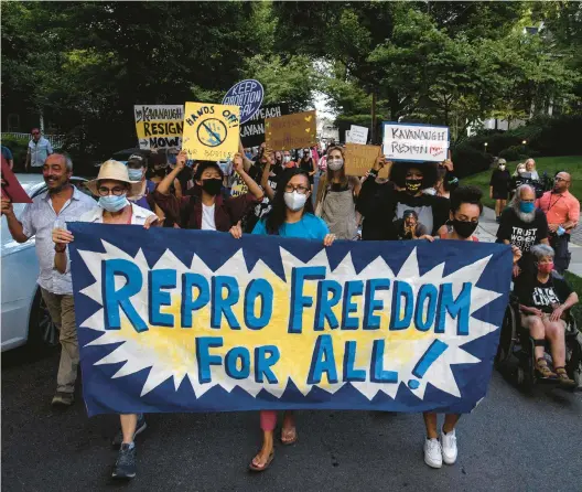  ?? NICHOLAS KAMM/GETTY-AFP 2021 ?? Abortion rights activists march Sept. 13 to the house of Supreme Court Justice Brett Kavanaugh in Chevy Chase, Maryland, following the court’s decision to uphold a Texas abortion law.
