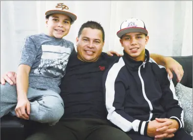  ?? Erik Trautmann / Hearst Connecticu­t Media ?? Jose Vasquez with his sons, Alan, 11, and Jose, 14, on Wednesday at their home in Norwalk.