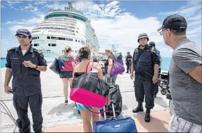  ?? DUTCH DEFENSE MINISTRY VIA AP ?? This photo provided by the Dutch Defense Ministry on Sept. 10 shows people walking toward a cruise ship anchored on St. Maarten, after the passage of Hurricane Irma.