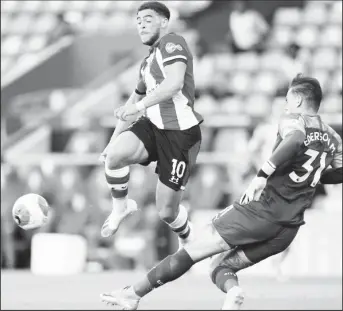  ??  ?? Manchester City’s Ederson clears from Southampto­n’s Che Adams yesterday as play resumes behind closed doors following the outbreak of the coronaviru­s disease (COVID-19) Will Oliver/Pool via REUTERS