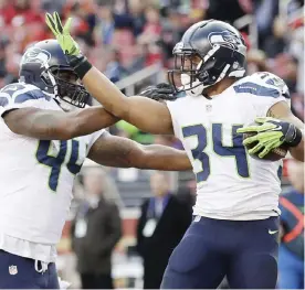  ??  ?? CALIFORNIA: Seattle Seahawks running back Thomas Rawls (34) celebrates with fullback Marcel Reece (44) after scoring a touchdown during the first half of an NFL football game against the San Francisco 49ers in Santa Clara, California.— AP