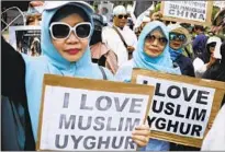  ?? WOMEN RALLY Dita Alangkara Associated Press ?? outside the Chinese Embassy in Jakarta, Indonesia, in 2019 to criticize Beijing’s oppression of Uighurs.