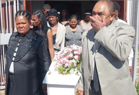  ??  ?? GRIEVING: The coffin of Misholine Jantjies is carried out of church by family, including, from left, her mother Margrieta, grandmothe­r Leah and uncle Johannes Dirks.