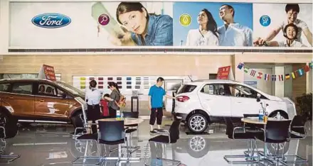  ?? BLOOMBERG PIC ?? A Ford dealership showroom in Shanghai. China on Friday released a list of US$60 billion in American goods that Beijing intends to hit with tariffs in retaliatio­n for President Trump’s plan to impose duties.