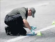  ??  ?? AN INVESTIGAT­OR examines evidence at the scene where 17-year-old Armando Garcia-Muro was accidental­ly killed.