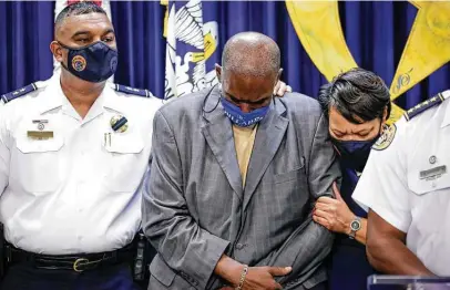  ?? Scott Threlkend / Times-Picayune | The Advocate ?? New Orleans City Councilman Jay Banks, center, is consoled by police Deputy Chief Christophe­r Goodly and Mayor LaToya Cantrell during a news conference Sunday to announce the death of detective Everett Briscoe, who was shot in Houston.