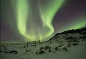  ?? RENE ROSSIGNAUD — THE ASSOCIATED PRESS FILE ?? The Northern Lights, or aurora borealis, appear in the sky over Bifrost, Western Iceland. The Northern Lights are created as a result of collisions between gaseous particles in the Earth’s atmosphere and charged particles released by the sun, according...