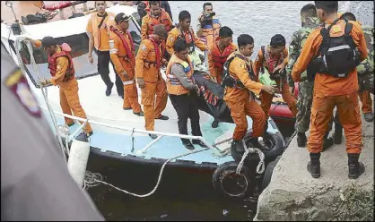  ?? AP ?? Indonesian search and rescue team carry a victim of a ferry sinking in Toba lake, North Sumatra yesterday.
