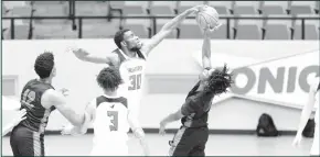  ?? Courtesy Photos/ Tony Claxton ?? Top Left: Jocoby Bishop battles fro a loose ball rebound. Top Right: Bonny Udoh stuffed a Western Texas player. The Hawks went on to play a great game winning easily 86-49.
By STEVE BELVIN