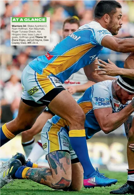  ??  ?? New Zealand Warriors captain and fullback Roger Tuivasa-Sheck is tackled by Jarryd Hayne of the Titans at Cbus Super Stadium on the Gold Coast yesterday.