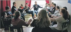  ??  ?? Colin MacDonald, Gaelic director and instructor (wearing glasses), and his students take part in a Gaelic song class as part of March break 2016 at the Gaelic College in St. Anns. A capacity crowd of youth from across the province, the Maritimes and as...