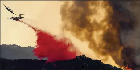  ?? NOAH BERGER — THE ASSOCIATED PRESS ?? An air tanker drops retardant to slow the Cave Fire burning in Los Padres National Forest above Santa Barbara on Tuesday.