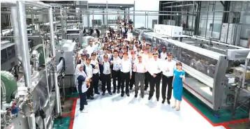  ??  ?? Tengku Syed Badarudin (front, fourth right) with the board of directors, senior management team, project team and employees at the facility after a tour of the new line.