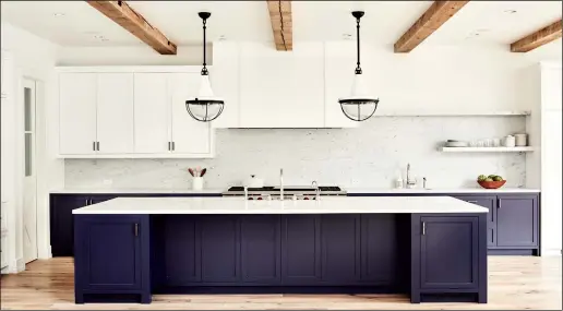  ?? Jenna Peffley/Betsy Burnham via AP ?? This undated photo shows an urban farmhouse style kitchen in a Manhattan Beach, Calif., home designed by Betsy Burnham, where the kitchen island offers ample storage and an extra prep sink for use while cooking.