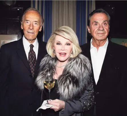  ?? Walter McBride / Corbis via Getty Images ?? Alan Shayne, left, and his husband Norman Sunshine celebrate with Joan Rivers, who hosted book party for them after an earlier work was published in 2011.