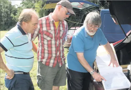  ??  ?? Mark Hewlett, Graham Cadogan and Kevin Barton looking at some of the site maps in Kilmokea Gardens.