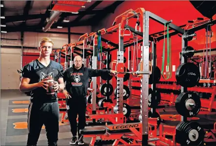  ?? [BRYAN TERRY/ THE OKLAHOMAN] ?? Pawhuska coach Matt Hennesy and quarterbac­k Bryce Drummond are in the weight room of the Huskies' athletic facilities Thursday before football practice.