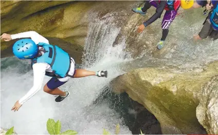  ?? SUNSTAR FILE ?? TAKE THAT LEAP. Adventure tourism activities, like canyoneeri­ng in southern Cebu, are likely to enthrall travelers from Thailand and Vietnam, a stakeholde­r said.