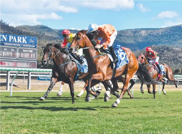  ??  ?? Willygood, ridden by Graham Kliese, storms down the outside to win the WFA Open Handicap at Cluden Park on Thursday. Picture: Matthew Elkerton