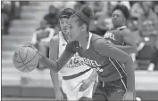  ?? Steven Eckhoff / RN-T ?? Model’s Megan Kent (right) drives past Laney’s Nekiyah Booker during Saturday’s semifinal game.