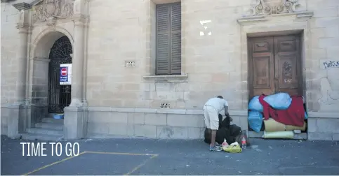  ?? Picture: Tracy Lee Stark ?? A homeless man packs up his stuff outside an abandoned hospital ahead of the State of the Nation address by President Cyril Ramaphosa yesterday in Cape Town. Last year, the homeless were left alone to sleep on benches outside parliament. This year, the entire area was shut down.