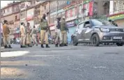  ??  ?? Security forces stand guard at the site of the grenade attack.
AFP