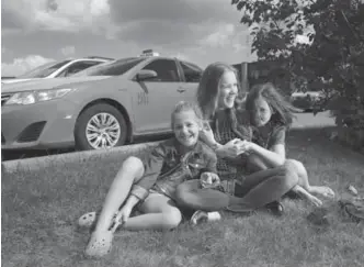  ?? RICHARD LAUTENS/TORONTO STAR ?? Hubbard with her daughters — Sara, 8, left, and Rachel, 10 — outside the company’s Eglinton Ave. E. offices.