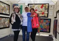  ??  ?? At the 2018 Hot Works Estero Fine Art Show, winning fiber artist Kevin Kichar celebrates with Marianne Mege la, artist judge (left), and Patty Narozny, the event’s executive producer.