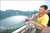  ?? ZHAO HUI / FOR CHINA DAILY ?? A worker cleans the guardrail of a sightseein­g platform near the world’s largest single-aperture telescope in Pingtang county, Guizhou province, in September.