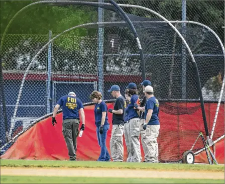  ?? AL DRAGO / NEW YORK TIMES
Washington Post ?? FBI personnel search near a batting cage after the shooting in Alexandria, Va. The gunman seemed to be a fervent opponent of President Donald Trump. He posted a petition calling for Trump’s impeachmen­t on Facebook with a chilling comment: “It’s time to...