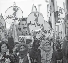  ??  ?? Syrian-Kurds march during a demonstrat­ion in the northeaste­rn Syrian city of Qamishli, against the Turkish assault on the border enclave of Afrin. AFP