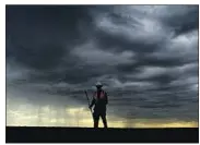  ?? Wally Skalij Los Angeles Times ?? A CREW member finishes a shift cleaning oil from Bolsa Chica State Beach amid Monday’s dark clouds.