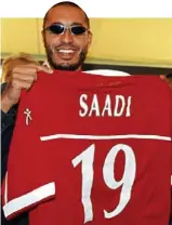  ??  ?? Signing: Colonel Gaddafi’s son Al-Saadi holds up his Perugia shirt in June 2003