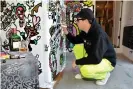  ??  ?? The Miami artist Vic Garcia painting a new community fridge. Photograph: Courtesy of Buddy System MIA