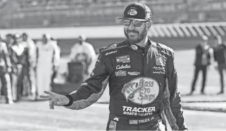  ?? NELL REDMOND/AP ?? NASCAR Cup Series driver Martin Truex Jr. walks to his car before a NASCAR Cup Series auto race at Charlotte Motor Speedway in Concord, N.C., in May.